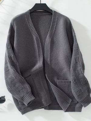 Dark gray chunky knit open-front cardigan with pockets and textured sleeves.