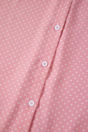 Pink polka dot print polyester button-up blouse with white buttons.