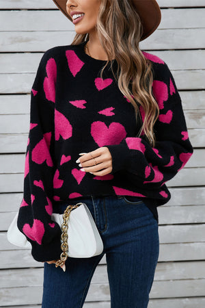 Black intarsia knit jumper with pink hearts, crew neck, long sleeves, acrylic blend.