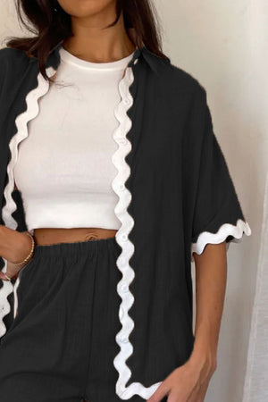 Black loungewear set with white scalloped trim on shirt and shorts.