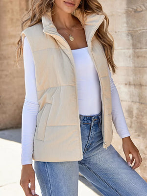 Off-white ribbed corduroy zip-up vest coat with stand collar and pockets.