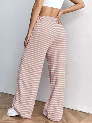 Pink striped ribbed wide-leg pants with drawstring waist and a relaxed fit.