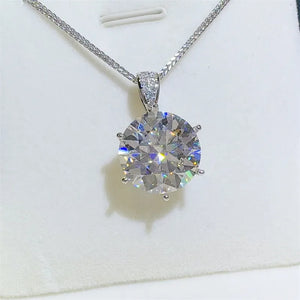 Silver moissanite solitaire pendant with a large, brilliant-cut stone and a delicate chain.