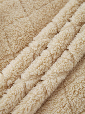 Tan textured teddy zip-up jacket detail showing plush fleece fabric.