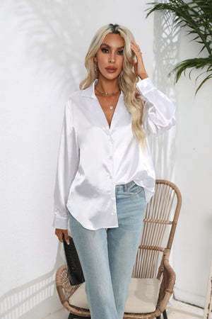White glossy satin button-down blouse with a relaxed fit, styled with jeans.