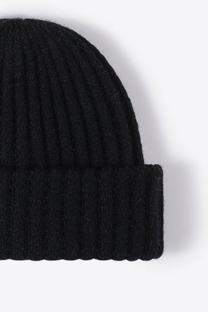 Black ribbed knit beanie with textured acrylic fabric.