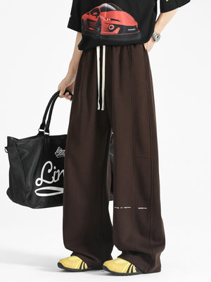 Chocolate wide-leg sweatpants with drawstring and stitched details.