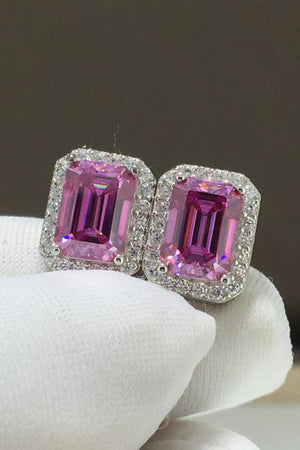 Emerald cut moissanite halo stud earrings in rose gold with pink center stones.