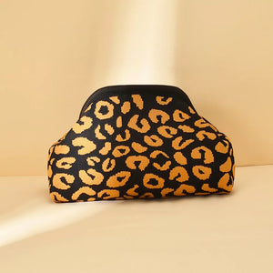 Vibrant knit clutch with black and orange leopard print pattern.