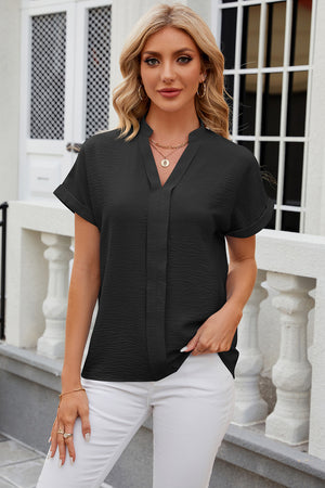 Black textured V-neck blouse with rolled short sleeves and a relaxed fit.