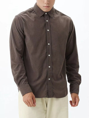 Brown corduroy long sleeve buttoned shirt with a spread collar.