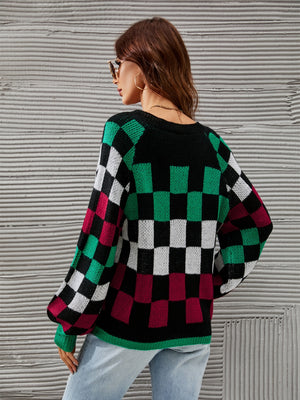 Black knit sweater with checkerboard pattern, puff sleeves, and crew neck.