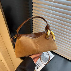 Taupe suede crossbody bag with brown leather trim and gold hardware.