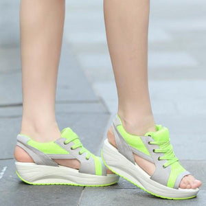 Sporty lace-up wedge sandals in lime green and gray with breathable mesh and cutouts.