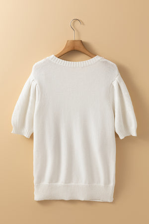 White cable knit sweater with puff sleeves and crew neck