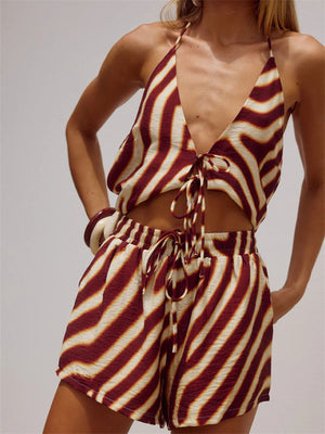 Backless halter neck two-piece set with deep v-neck top and flowy shorts in a maroon and cream stripe pattern.