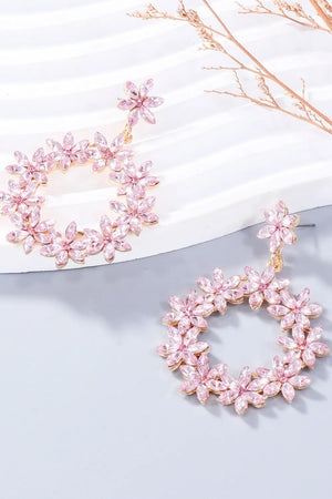 Blush pink floral halo drop earrings with crystal accents and gold tone alloy.