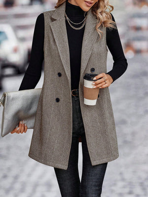 Herringbone tailored vest in taupe with double-breasted closure and collared neckline.