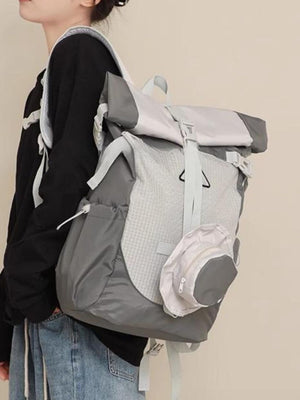 Sleek roll-top nylon backpack in light gray and dark gray with a textured front panel and detachable pouch.