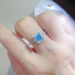 Silver ring with ice blue square halo diamond accent