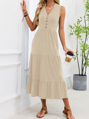 Apricot tiered midi dress with notched V-neck and decorative buttons.