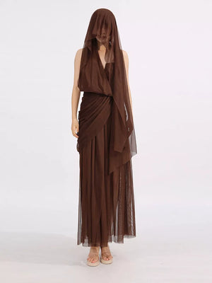 Draped one-shoulder maxi dress in coffee brown with sheer overlay and flowing skirt.