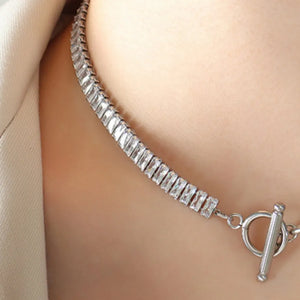 Silver asymmetric crystal link necklace with baguette-cut stones and toggle clasp