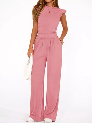Pink maternity one-piece with ruffled cap sleeves, crew neck, and wide-leg pants.