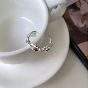 Sterling silver ring with interconnected oval links and a delicate chain design