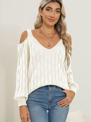 White cable knit sweater with cold shoulder detail and button accents