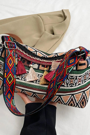 Geometric embroidered shoulder bag with colorful tassels and patterned strap