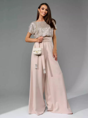 Apricot silver sequin wide-leg jumpsuit with tie waist and embellished belt detail.