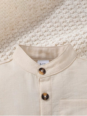 Beige linen blend baby shirt with mandarin collar and two button details.