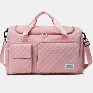 Quilted duffel bag in Dusty Pink with multiple pockets and olive accents.