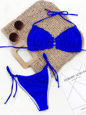 Royal blue bikini set with ruffled tie halter top and side tie bottoms.