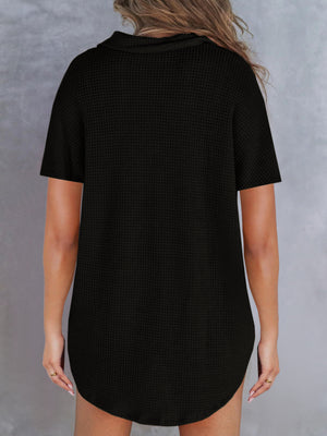 Black waffle knit polo shirt with button detail and short sleeves