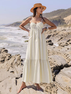 Cream ruched sweetheart neck maxi dress with crochet bodice and tassels.