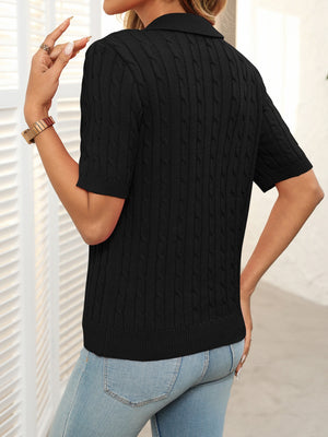 Black cable knit polo sweater with short sleeves and collar.