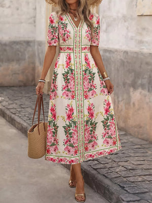White floral midi dress with V-neck, short sleeves, and defined waist.