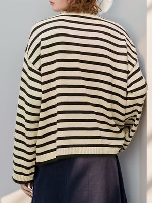 Nautical stripe sweater in pastel yellow with button shoulder detail.