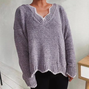 Lavender v-neck sweater with scalloped trim and ribbed knit texture.