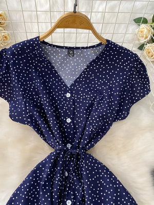 Dark Blue polka dot maxi dress with V-neck, button front, short sleeves, and tie belt.