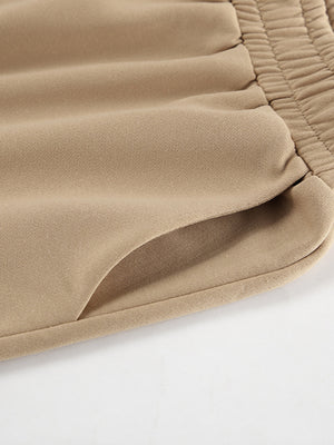 Camel quarter zip top and pants set detail showing elastic waistband and pocket.