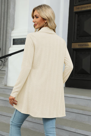 Drape-front cable knit cardigan in Sand, featuring a textured pattern and long sleeves.