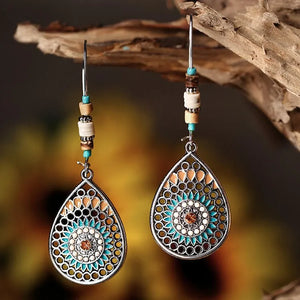 Bohemian silver drop earrings with mandala design, turquoise and tan enamel, and wood beads.