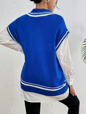 Blue acrylic knit vest with white varsity stripes and pearl trim detail, layered over a white shirt.