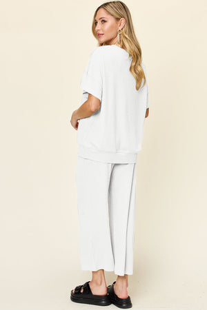 White waffle knit lounge set with short sleeve top and wide leg pants.