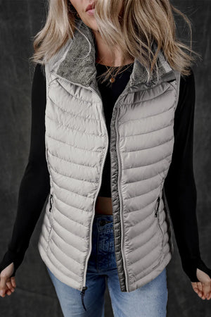Gray quilted puffer vest with a soft fleece collar and zipper closure.