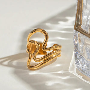 Gold sculptural wave ring with abstract, adjustable design