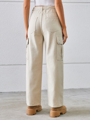 Tan denim cargo pants with wide legs and buttoned flap pockets.
